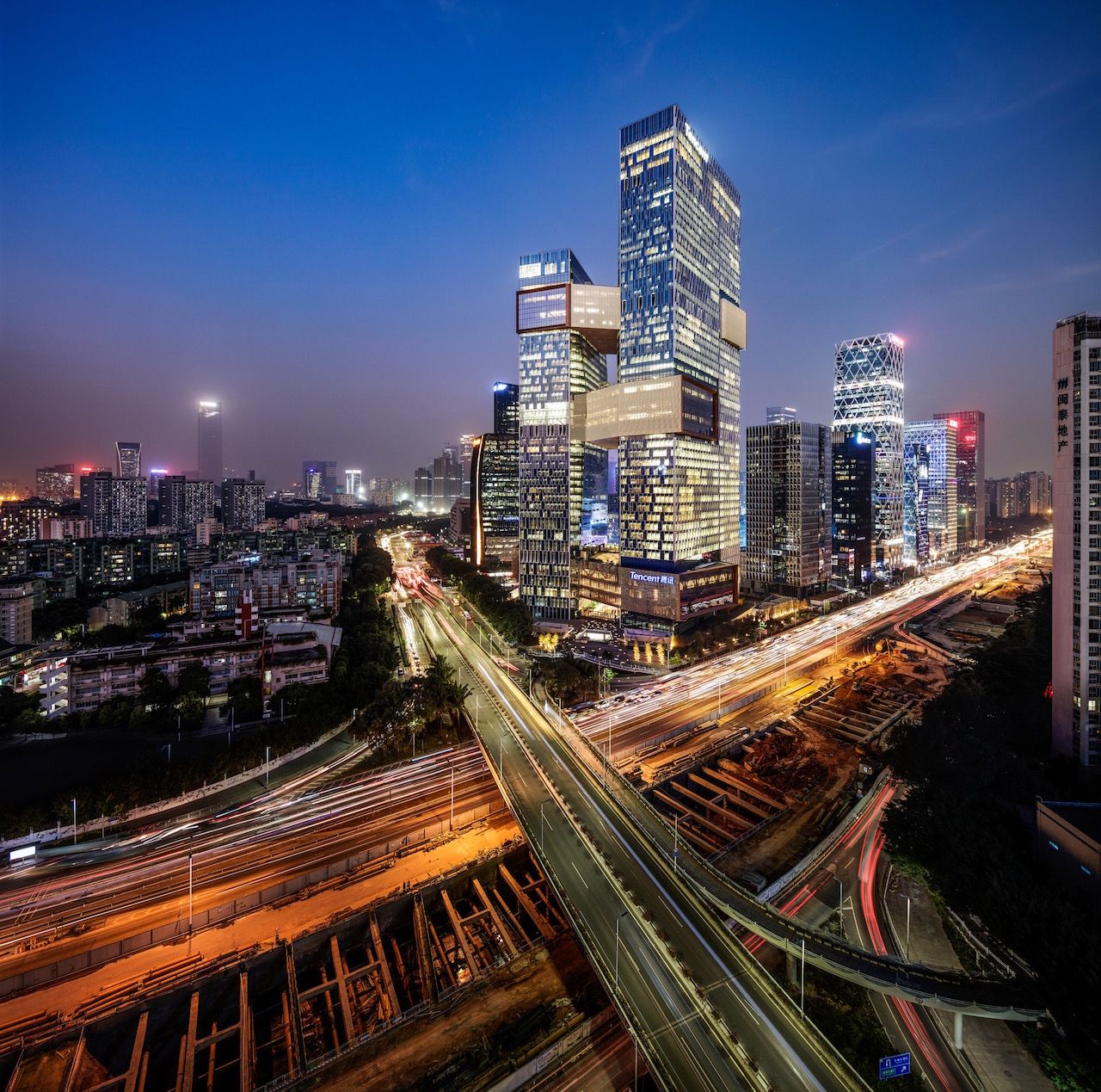 Tencent's towers overlook a busy road and other urban areas.