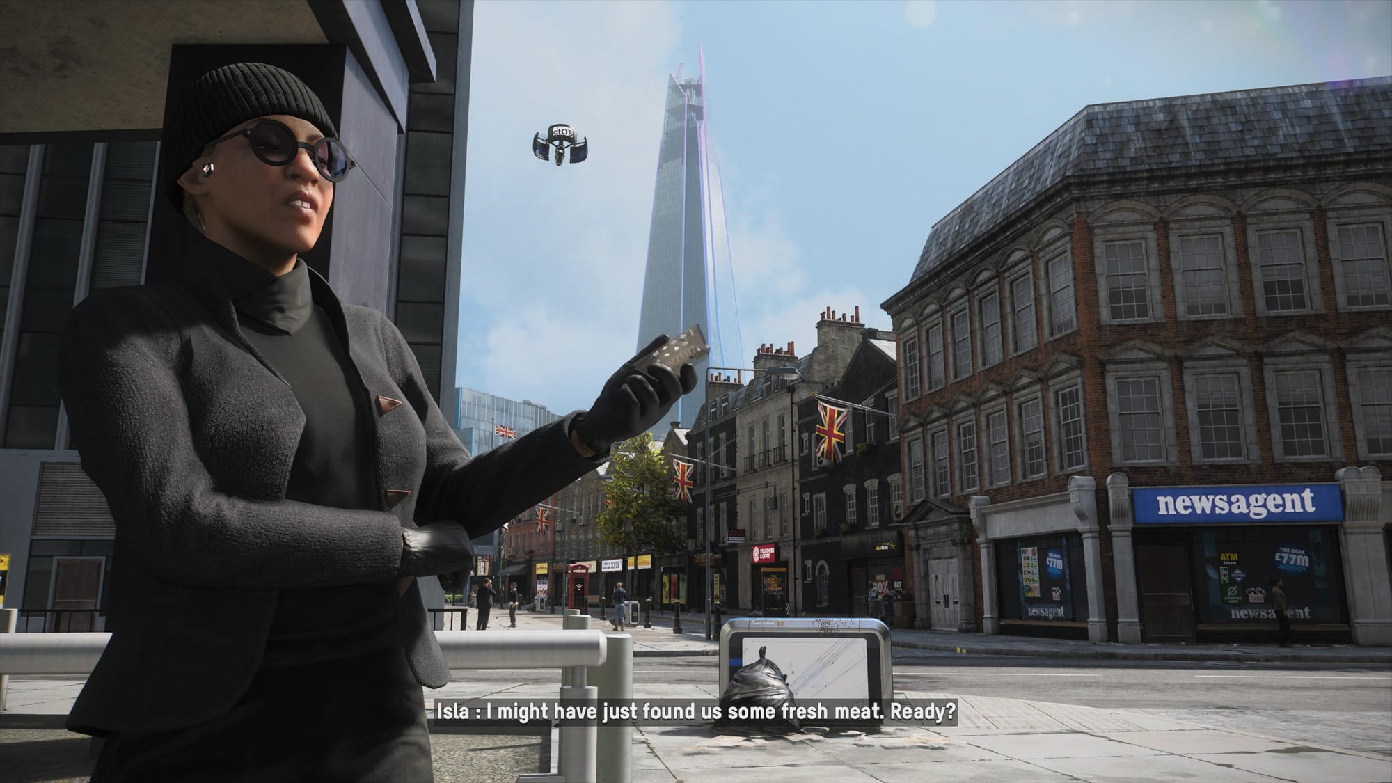 A black clad woman stands holding a phone on a London street, a tower behind her and a drone in the sky 